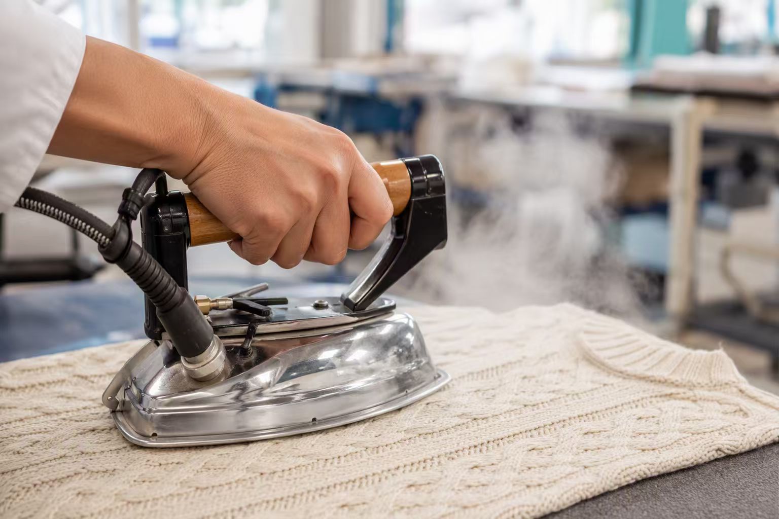 Finishing — steam ironing a knitwear piece